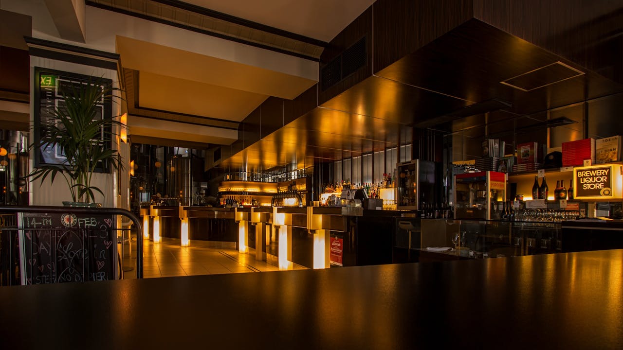 why-choose-us-02 Stylish modern restaurant interior with warm lighting, elegant design, and luxurious ambiance at night.